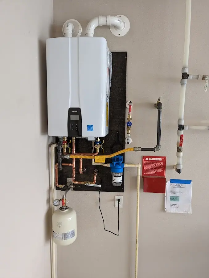 Professional plumber installing copper piping in a Oasis home